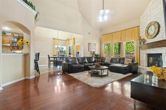 a living room with fireplace furniture and a large window