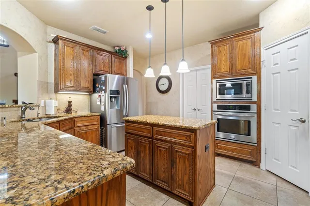 a kitchen with stainless steel appliances granite countertop a sink and stove