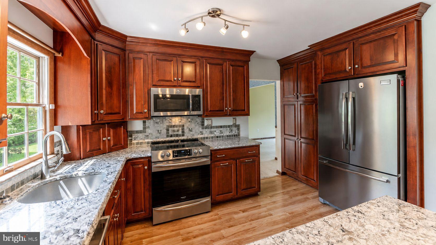 223 Trythall Road Elverson, PA 19520 - Photo 23 of 78 a kitchen with stainless steel appliances granite countertop a refrigerator stove and sink