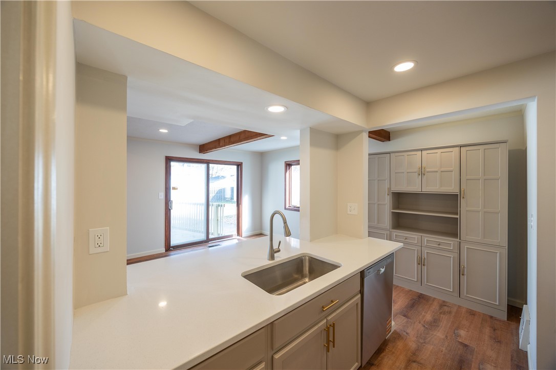 3797 Northwood Road Cleveland, OH 44118 - Photo 16 of 49 Kitchen featuring recessed lighting, dark wood-type flooring, dishwasher, light stone countertops, and beam ceiling
