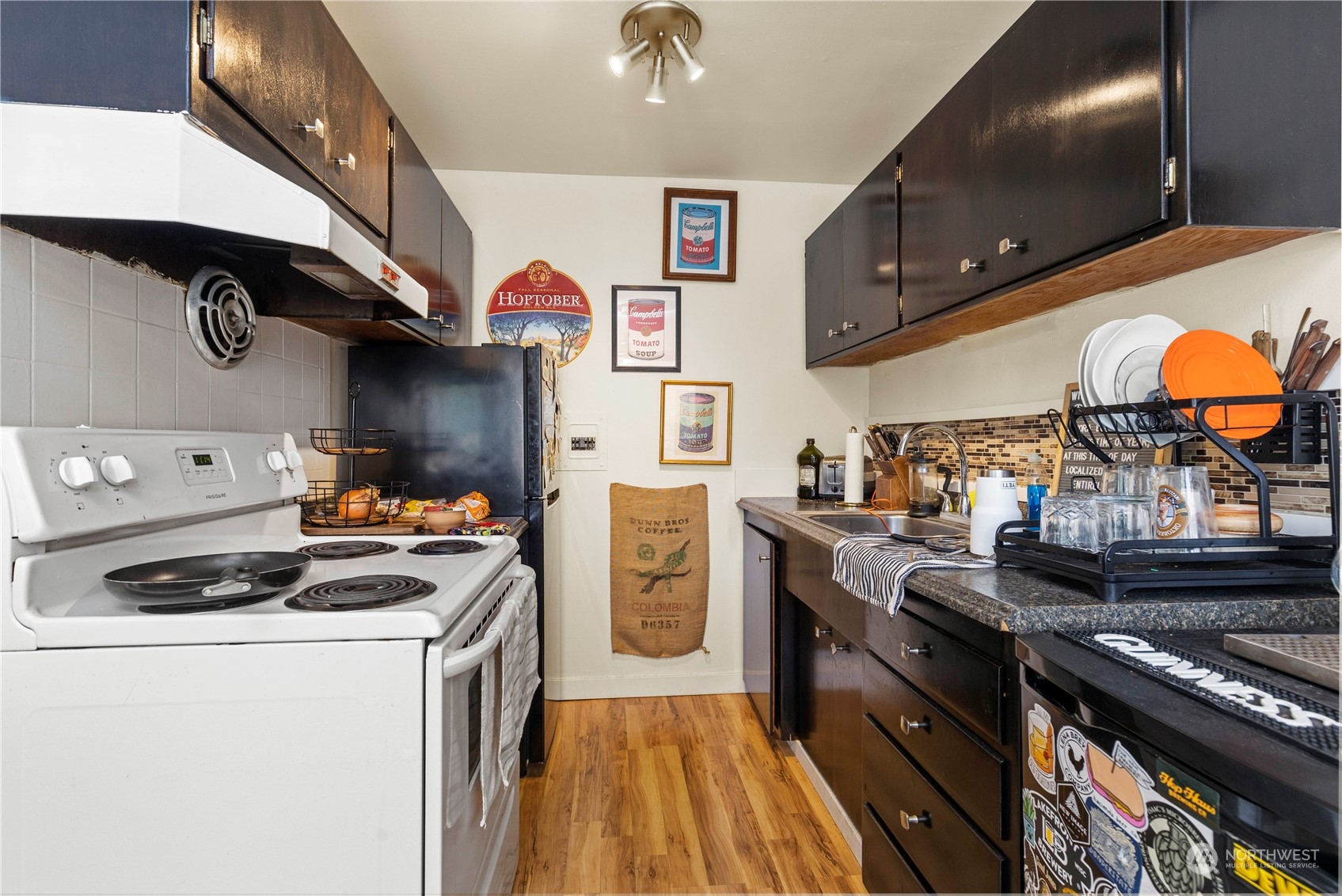 601 East Roy Street Seattle, WA 98102 - Photo 15 of 26 a kitchen with stainless steel appliances granite countertop a stove and a refrigerator