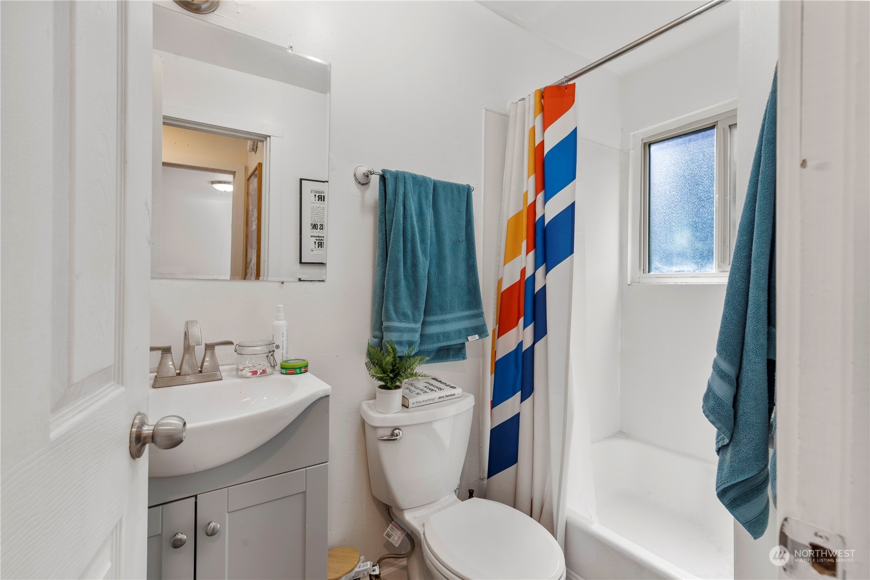 601 East Roy Street Seattle, WA 98102 - Photo 16 of 26 a bathroom with a toilet sink and mirror