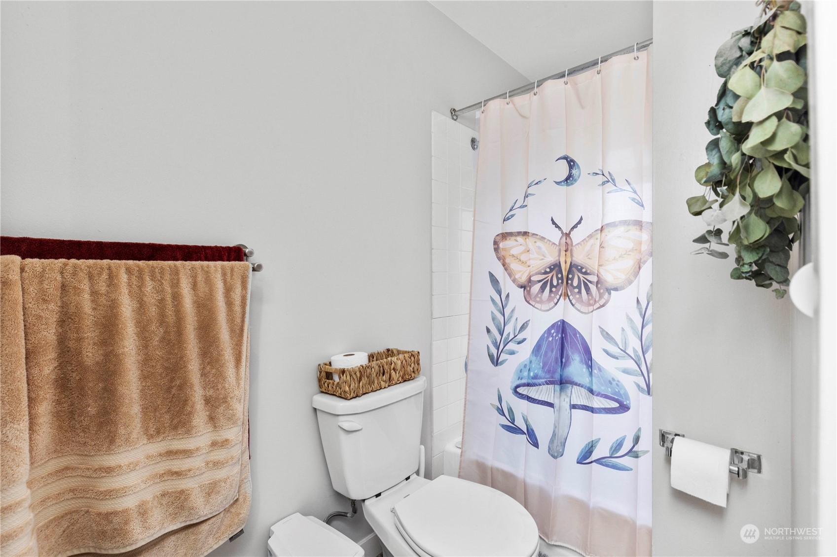 601 East Roy Street Seattle, WA 98102 - Photo 25 of 26 a white toilet sitting next to a shower curtain