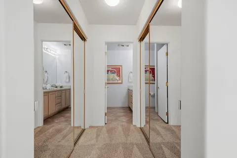 a view of a hallway view with staircase and bathroom