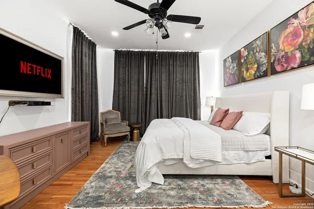 a bedroom with a bed and flat screen tv