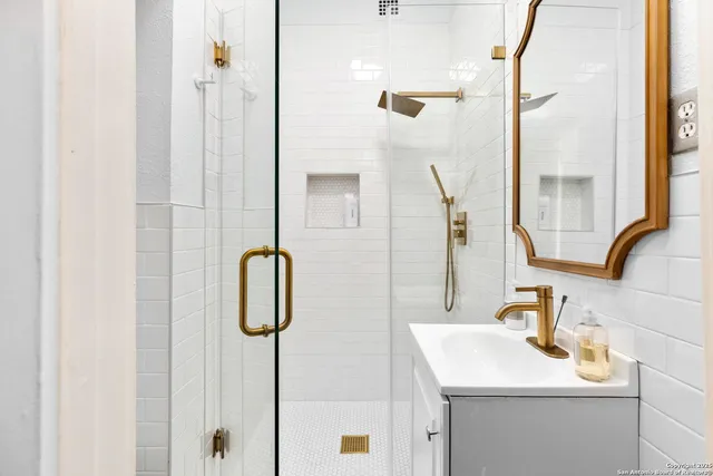 a bathroom with a sink vanity and a mirror