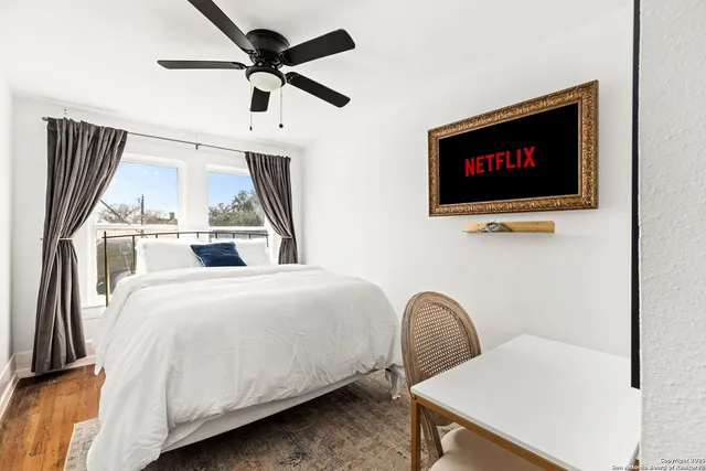 a bedroom with a bed and a flat screen tv