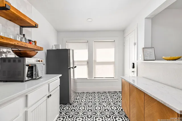 a kitchen with stainless steel appliances a refrigerator sink and microwave