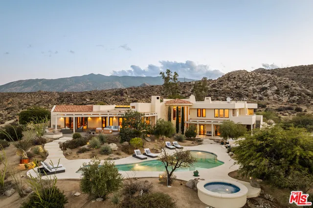 a view of a house with swimming pool and a chairs