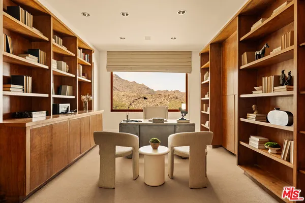 a dining room with furniture and a large window