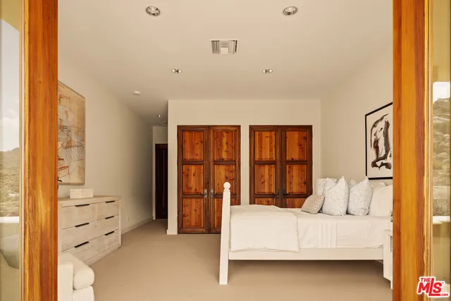 a bed room with a bed and a large window