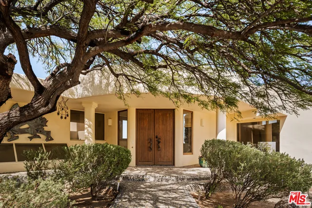 front view of a house with a tree