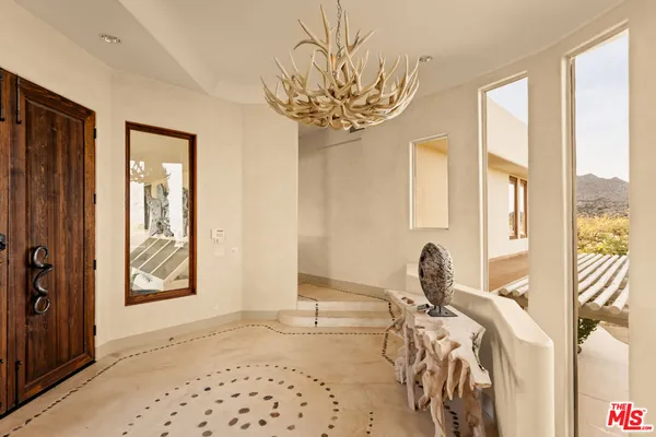 a view of a room with windows and furniture