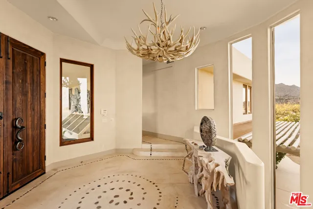 a view of a room with windows and furniture