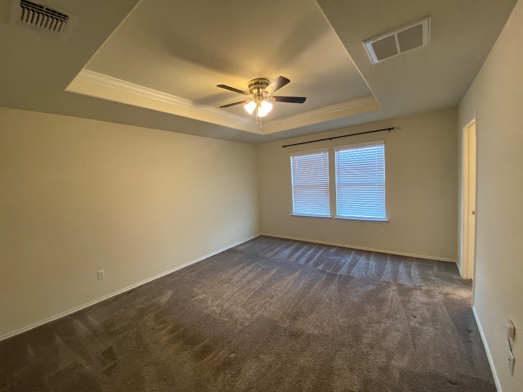 97 Quarryman Drive Hutto, TX 78634 - Photo 24 of 37 en empty room with windows and ceiling fan