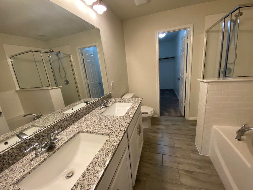 97 Quarryman Drive Hutto, TX 78634 - Photo 25 of 37 a bathroom with a granite countertop sink and a mirror