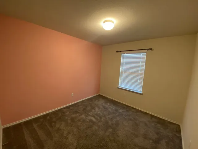 an empty room with a empty space and windows