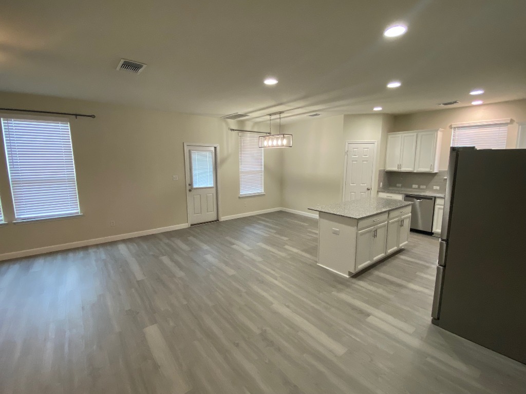 97 Quarryman Drive Hutto, TX 78634 - Photo 4 of 37 a room with stairs and a wooden floor