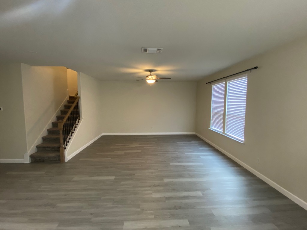 97 Quarryman Drive Hutto, TX 78634 - Photo 5 of 37 a view of an empty room with wooden floor and a window
