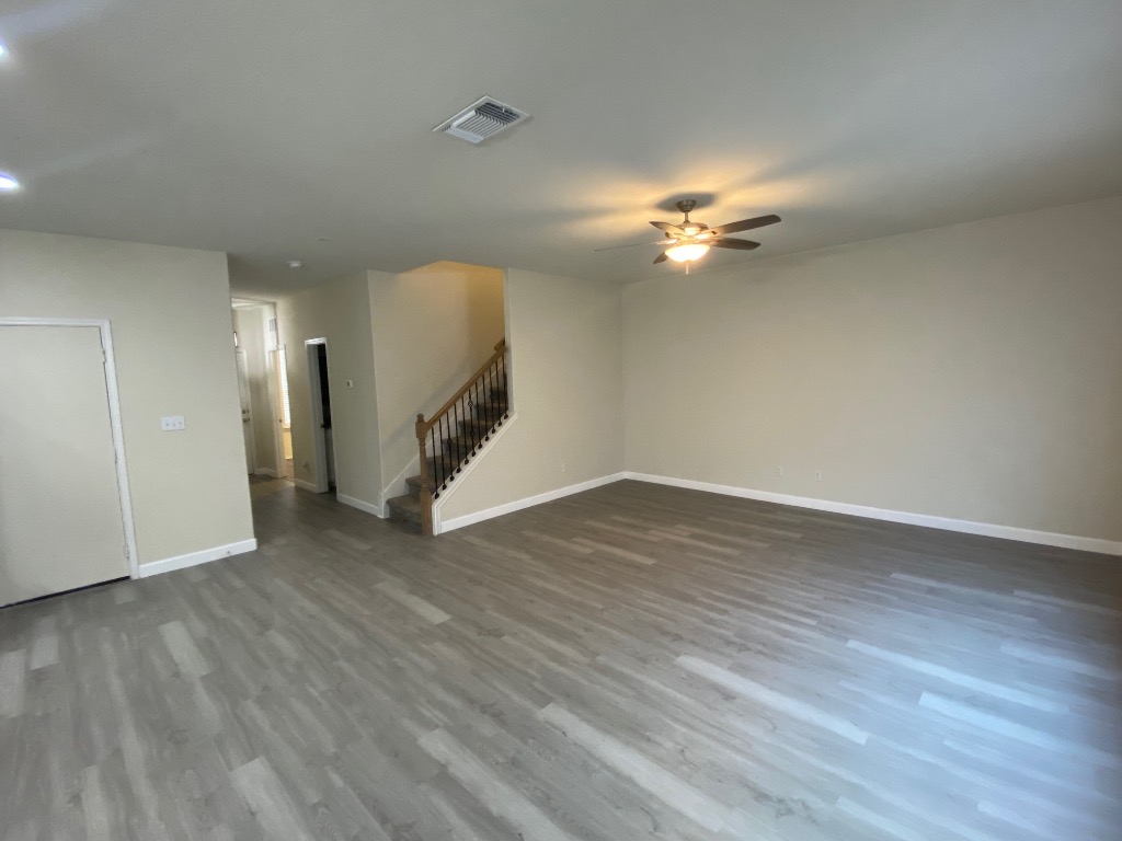 97 Quarryman Drive Hutto, TX 78634 - Photo 6 of 37 a view of a room with wooden floor and a ceiling fan