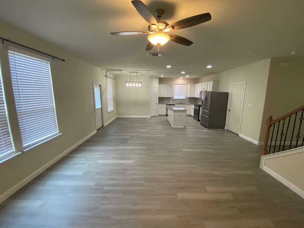 97 Quarryman Drive Hutto, TX 78634 - Photo 8 of 37 a view of a livingroom with a chair and a ceiling fan
