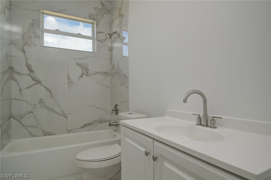 6017 Ruth Avenue North Lehigh Acres, FL 33971 - Photo 13 of 25 a bathroom with a sink toilet and shower