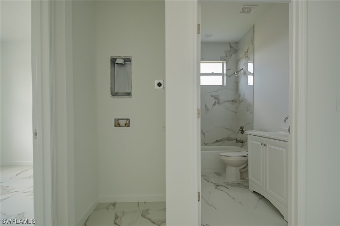 6017 Ruth Avenue North Lehigh Acres, FL 33971 - Photo 16 of 25 a bathroom with a toilet a sink and shower