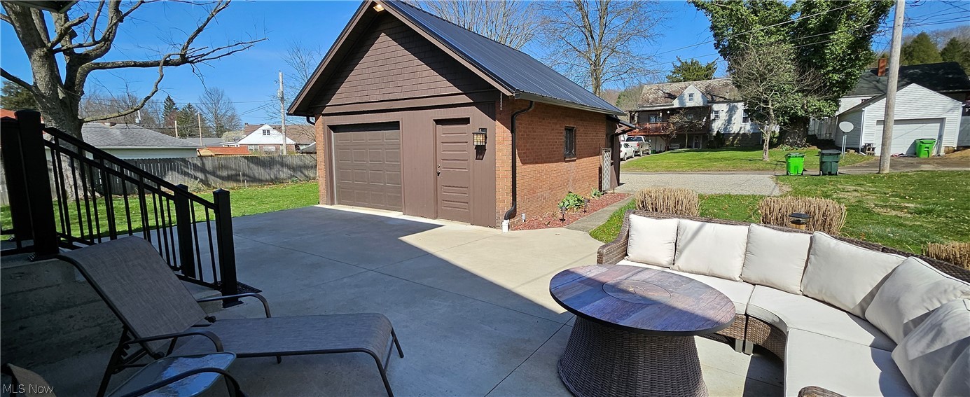 1050 Cambridge Road Coshocton, OH 43812 - Photo 16 of 50 View of terrace featuring an outdoor hangout area, an outdoor structure, and a garage