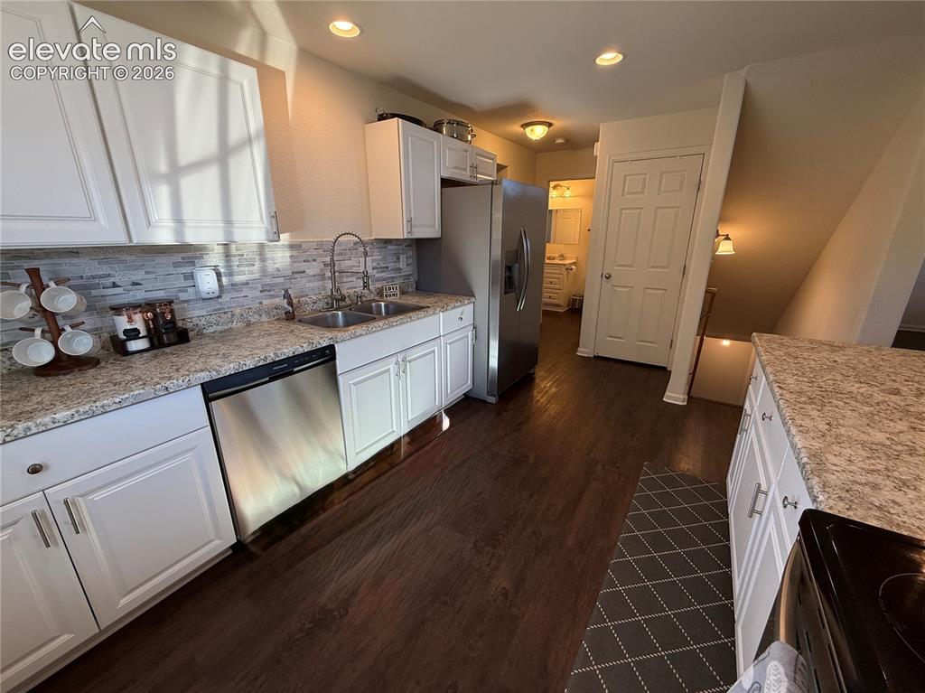 61 Stripling Lane Divide, CO 80814 - Photo 9 of 40 a kitchen with stainless steel appliances granite countertop a sink stove and cabinets