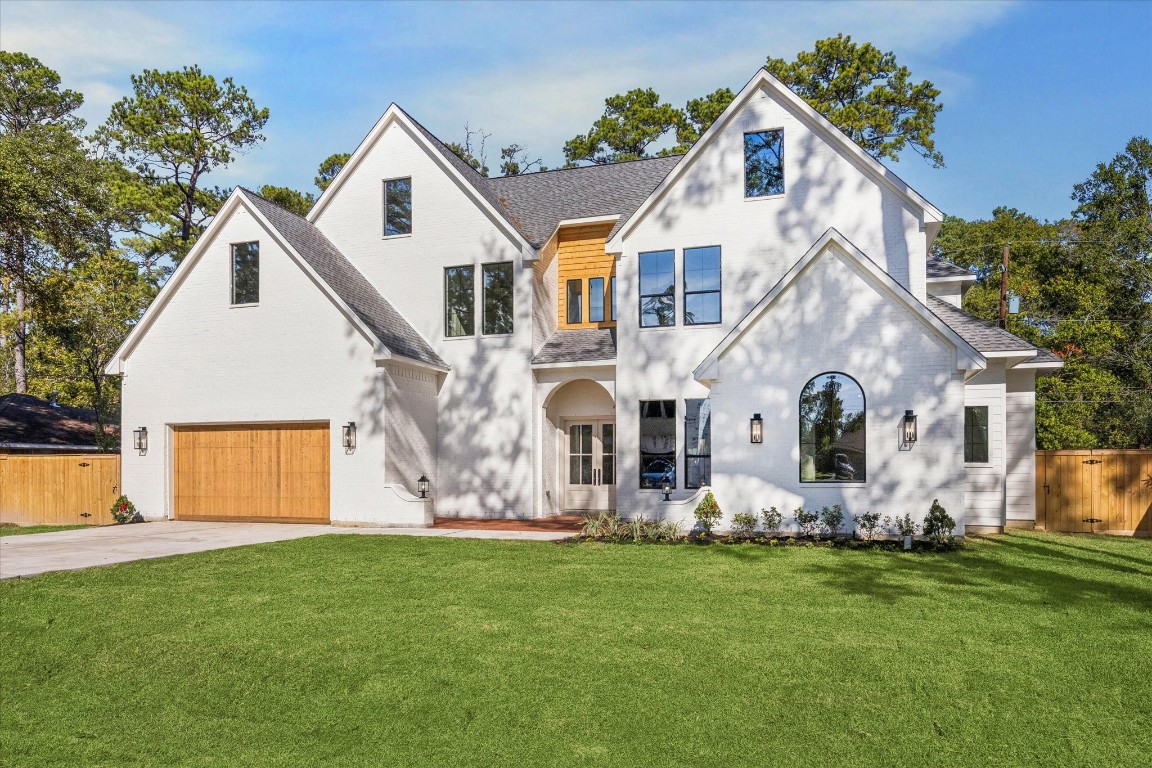 a front view of house with yard and green space