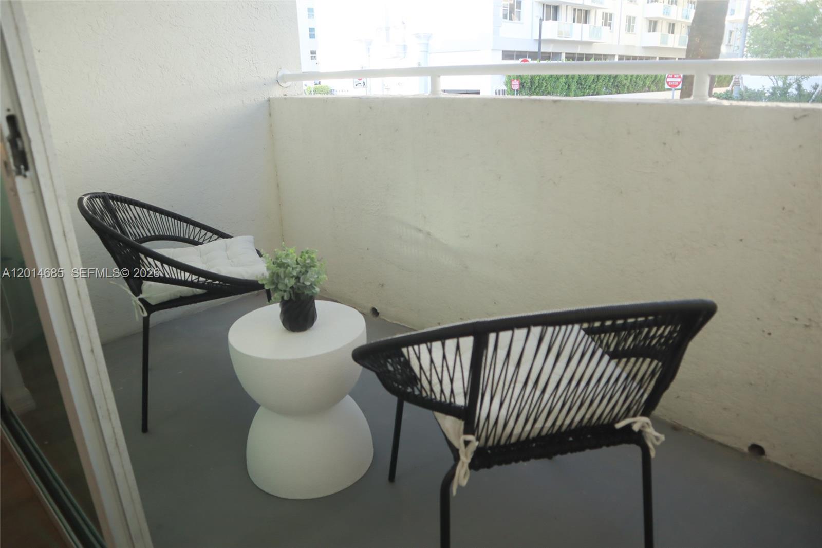 9172 Collins Avenue, Unit 212 Surfside, FL 33154 - Photo 13 of 23 a close view of light fixtures and a table chair