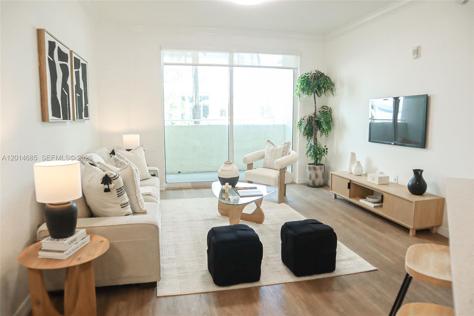 9172 Collins Avenue, Unit 212 Surfside, FL 33154 - Photo 15 of 23 a living room with furniture and a large window