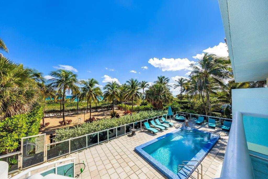 9172 Collins Avenue, Unit 212 Surfside, FL 33154 - Photo 20 of 23 a view of a swimming pool with a patio