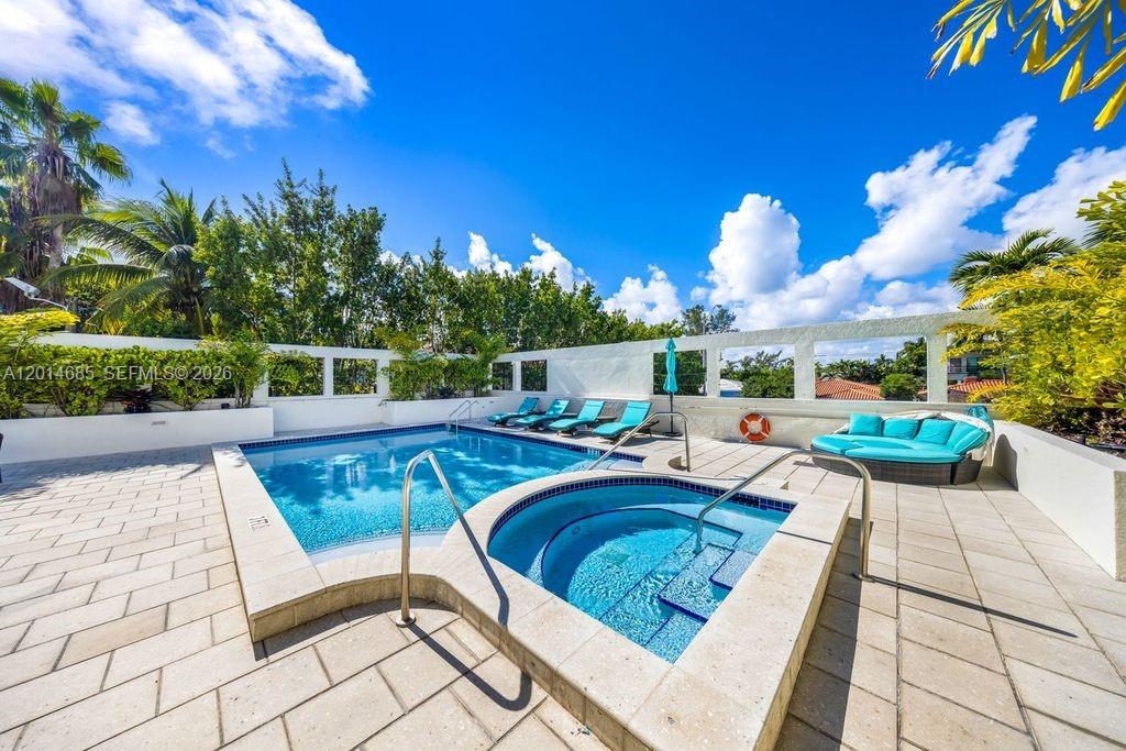9172 Collins Avenue, Unit 212 Surfside, FL 33154 - Photo 22 of 23 a view of a swimming pool with a patio