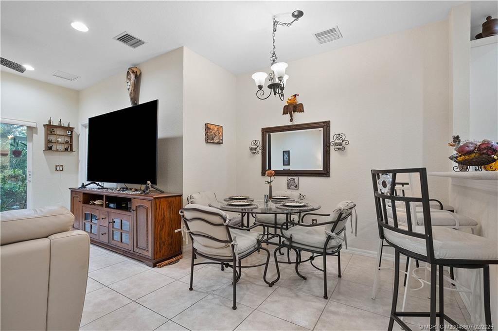 1580 Southeast Sheffield Terrace, Unit 101 Stuart, FL 34994 - Photo 12 of 39 a view of a livingroom with furniture and a flat screen tv