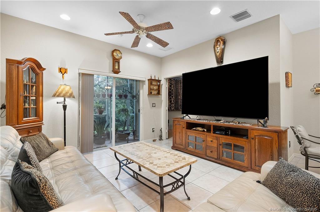 1580 Southeast Sheffield Terrace, Unit 101 Stuart, FL 34994 - Photo 14 of 39 a living room with furniture and a flat screen tv