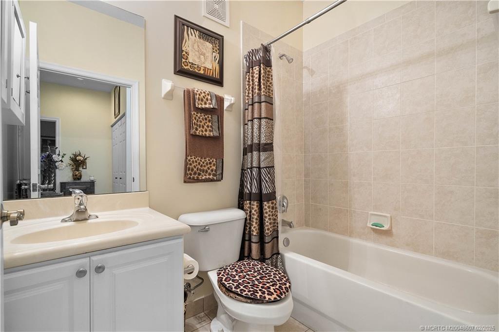 1580 Southeast Sheffield Terrace, Unit 101 Stuart, FL 34994 - Photo 22 of 39 a bathroom with a sink toilet and shower