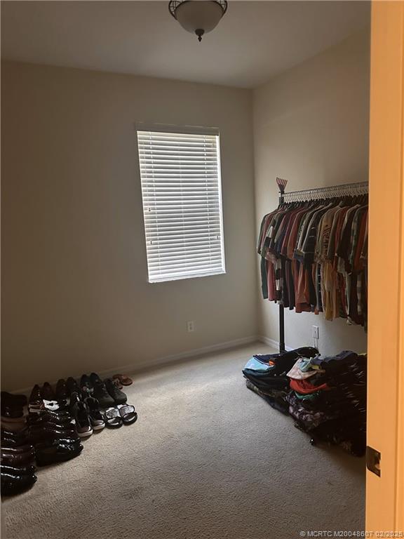 1580 Southeast Sheffield Terrace, Unit 101 Stuart, FL 34994 - Photo 23 of 39 a view of a room with gym equipment and a window