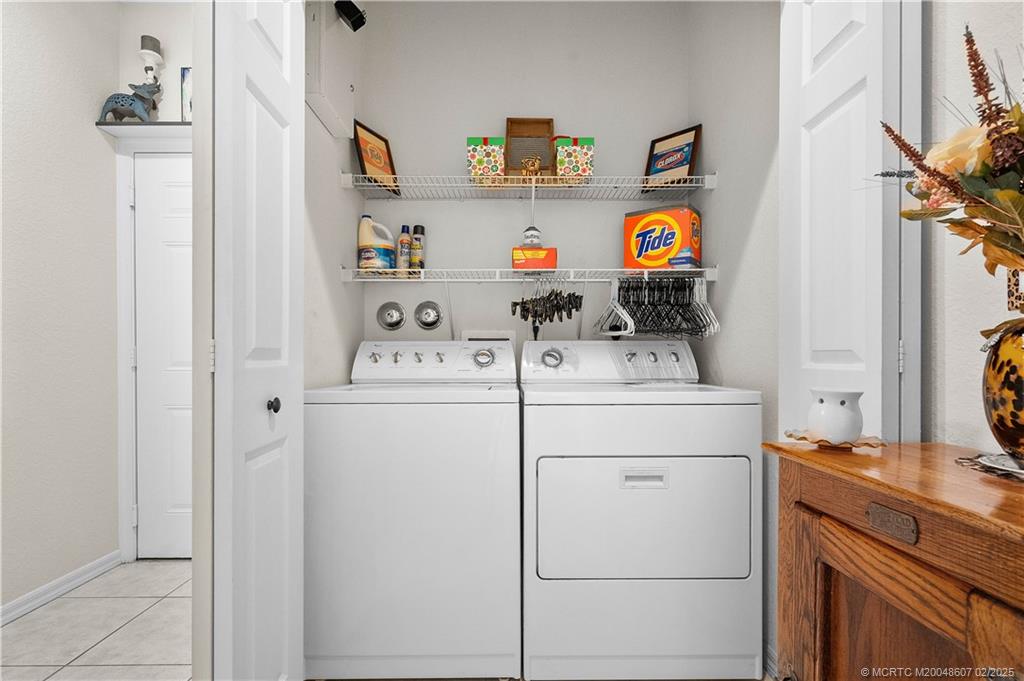 1580 Southeast Sheffield Terrace, Unit 101 Stuart, FL 34994 - Photo 25 of 39 a utility room with dryer and washer