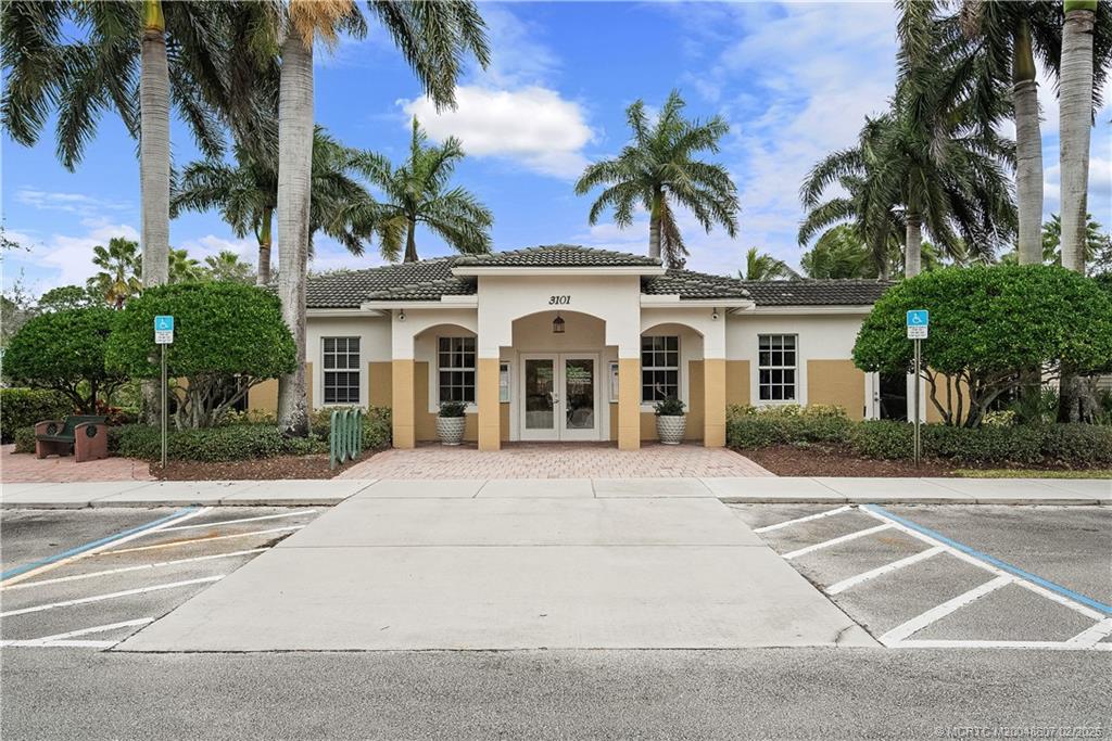 1580 Southeast Sheffield Terrace, Unit 101 Stuart, FL 34994 - Photo 29 of 39 front view of a house with a yard