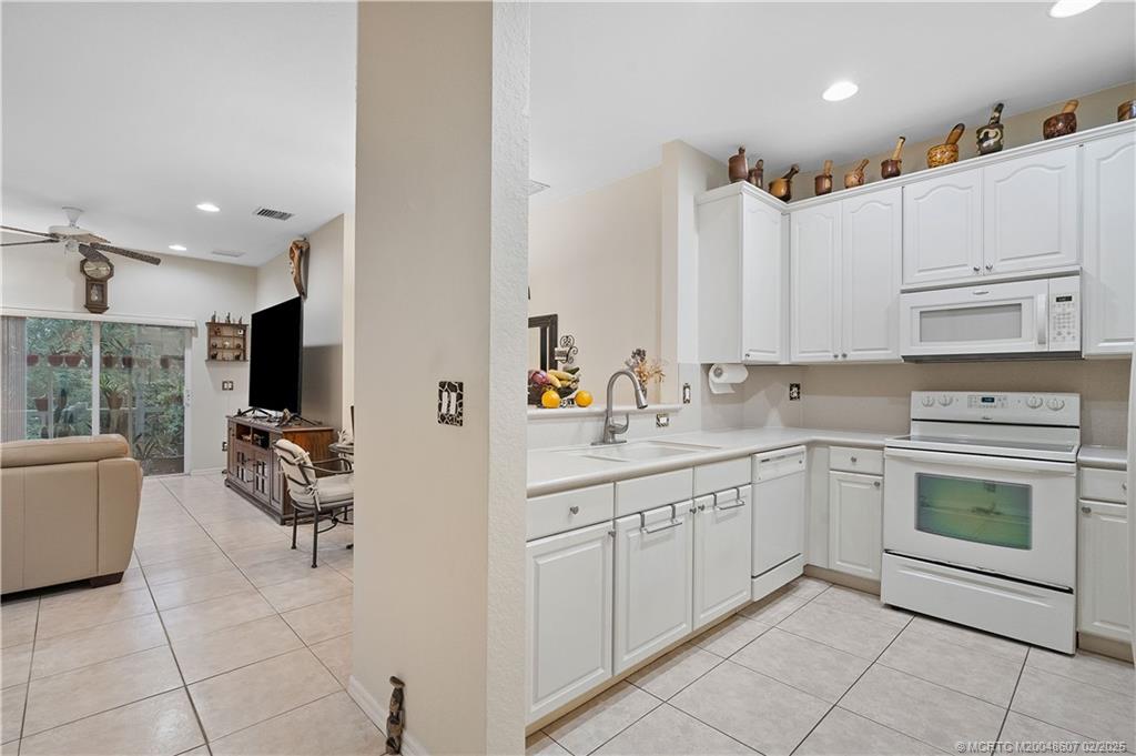1580 Southeast Sheffield Terrace, Unit 101 Stuart, FL 34994 - Photo 8 of 39 a kitchen with a sink and cabinets