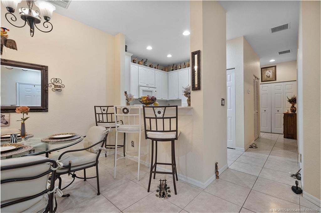 1580 Southeast Sheffield Terrace, Unit 101 Stuart, FL 34994 - Photo 9 of 39 a view of a dining room with furniture