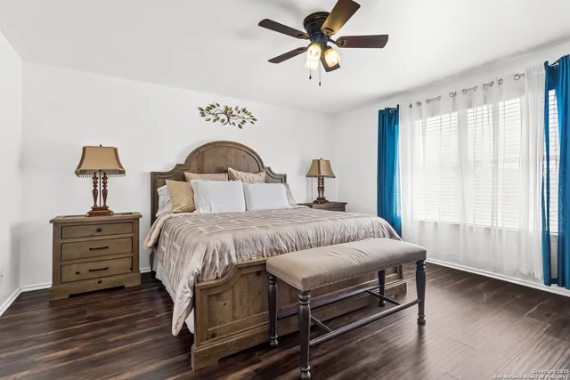 a bedroom with a bed chandelier and a window