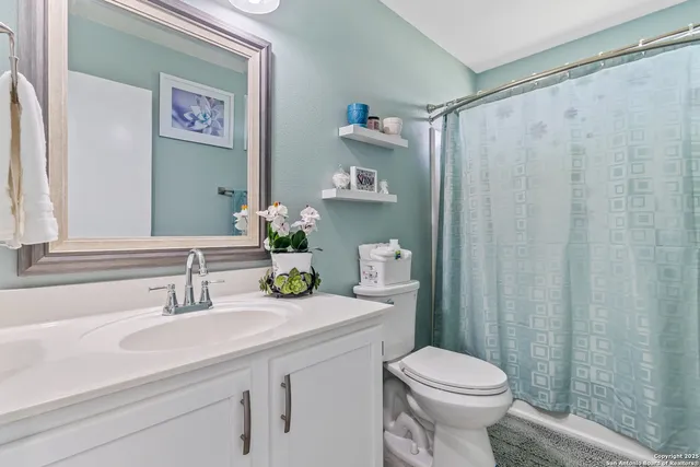 a bathroom with a sink a toilet and a mirror