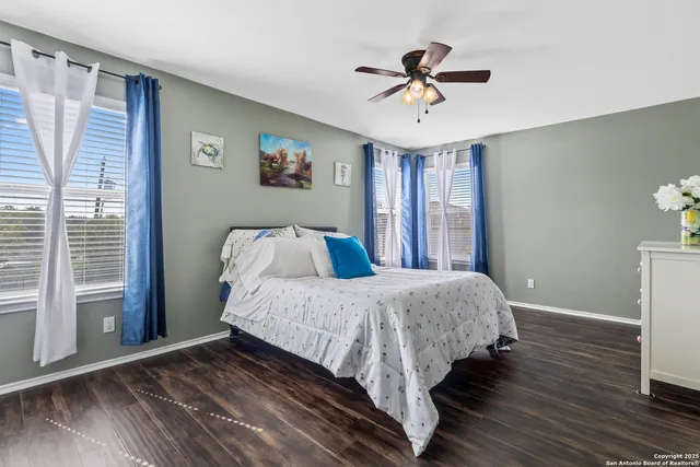 a bedroom with a bed and a ceiling fan