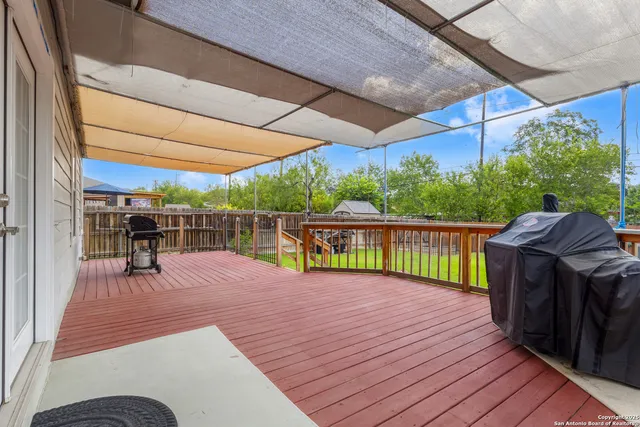 a view of a deck with wooden floor and outdoor seating