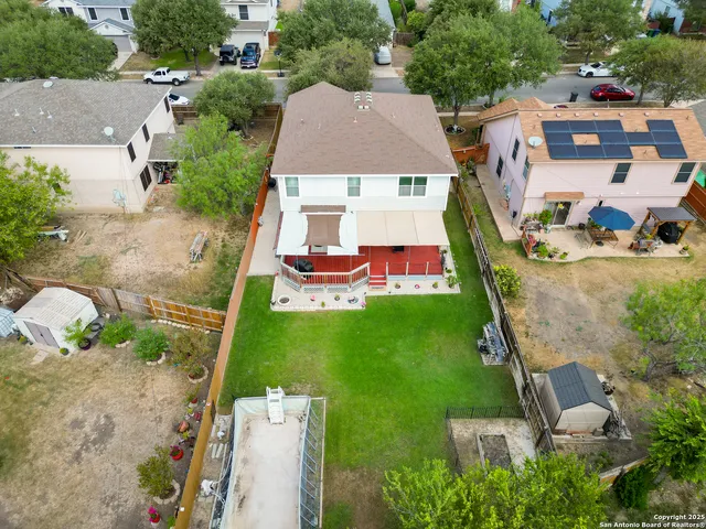 an aerial view of a house with a garden and lake view
