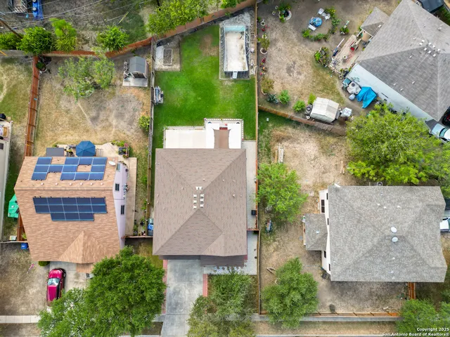 an aerial view of a house with a yard and a fountain