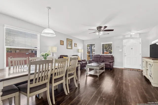a view of a livingroom with furniture a window and wooden floor