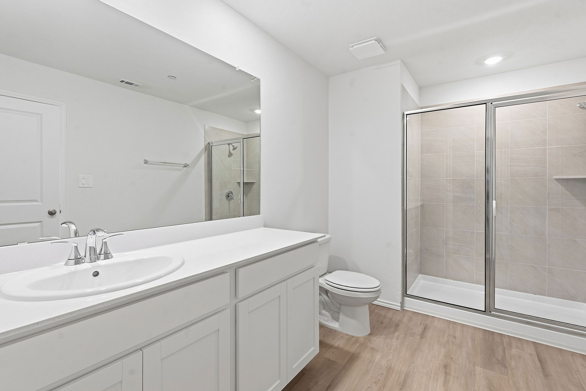 164 Cinnabar Lane, Unit 2 Kyle, TX 78640 - Photo 13 of 21 Bathroom featuring a single vanity with a white countertop, chrome faucet, and a large wall-mounted mirror